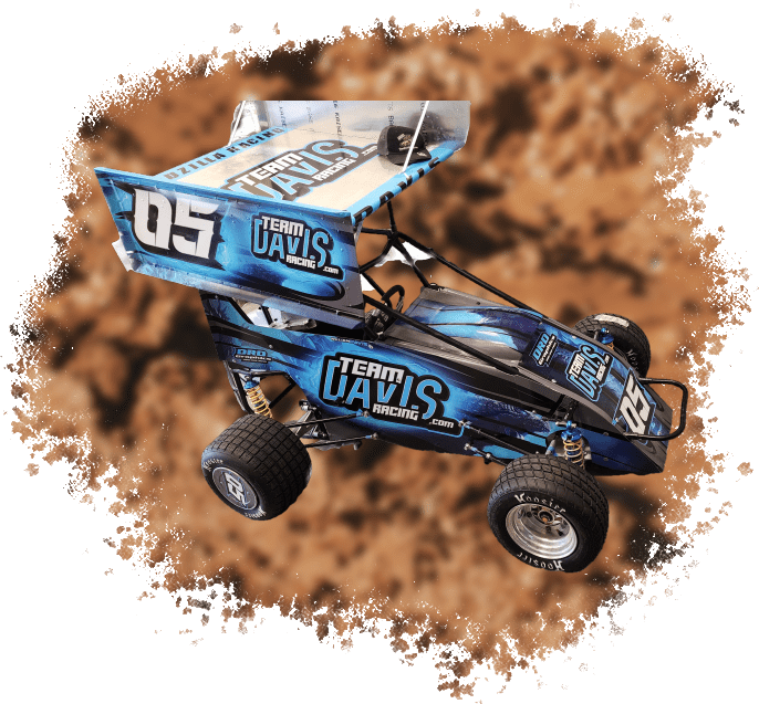 A blue and black dirt sprint car in the sand.