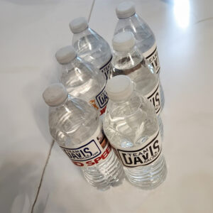 A group of water bottles sitting on top of a floor.