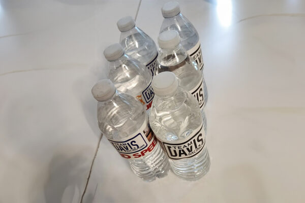 A group of water bottles sitting on top of a floor.