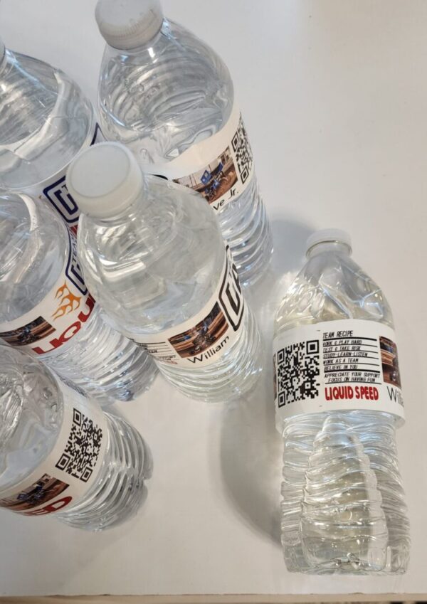 A group of bottled water with labels on them.