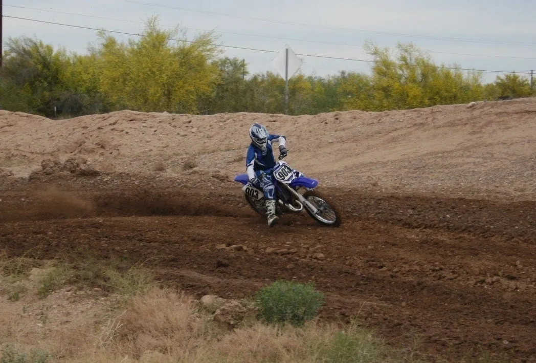 A person on a dirt bike riding in the dirt.