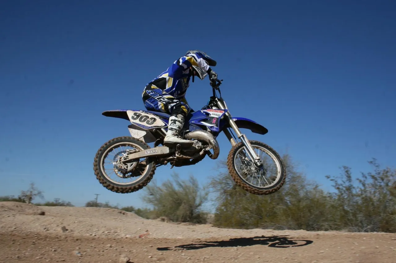 A person on a dirt bike jumping in the air.