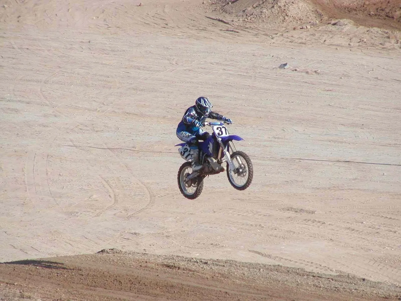 A person on a dirt bike in the air.