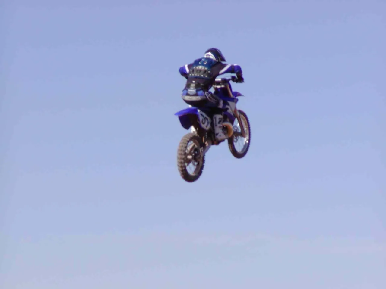 A person on a motorcycle in the air.