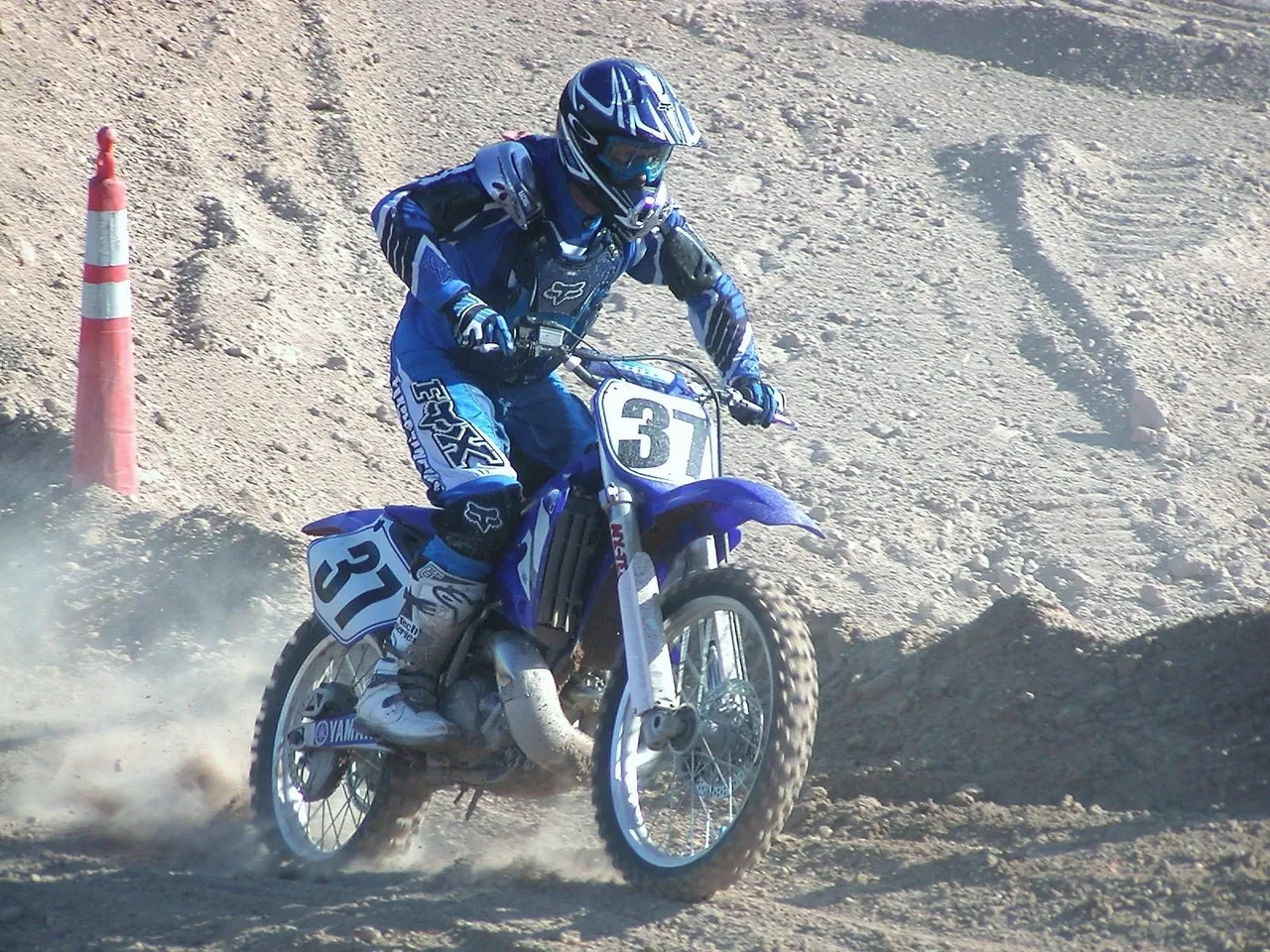 A person on a dirt bike riding down the side of a hill.